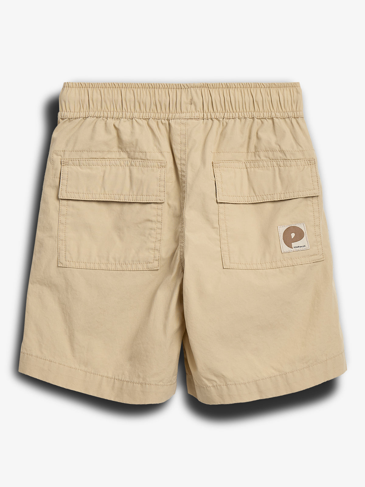 Beige shorts display two back pockets with flaps and an elastic waistband; a small square logo on the right pocket reads "Polisport." Set against a plain white background.