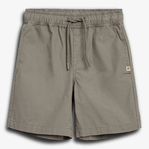 Gray shorts with an elastic waistband and drawstring, featuring two side pockets and a small logo patch on the right leg's seam, placed against a plain white background.