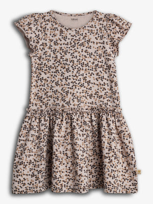 A child's dress with flutter sleeves features a pattern of small, clustered floral designs in black and brown. It is set against a plain white background.