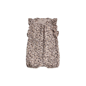 A floral-patterned baby romper with ruffled sleeves is displayed against a plain background. The text inside reads, "Pomp de Lux ORGANIC COTTON."
