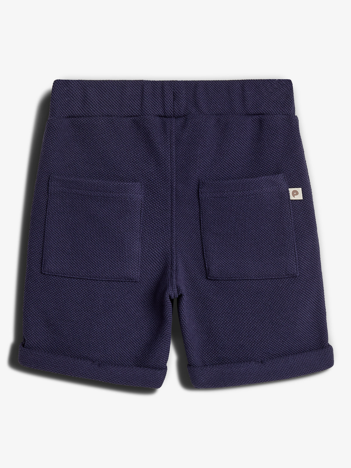 Navy blue shorts feature two back pockets and a small label. The waistband is elastic, and cuffs are rolled. They are displayed against a white background.