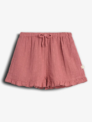 Pink shorts featuring a drawstring waistband and ruffled hem; small embroidered patterns adorn the fabric, adding texture. Displayed against a white background.