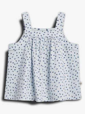 A light blue sleeveless top with thin straps, adorned with a pattern of small blue flowers, displayed against a plain white background.