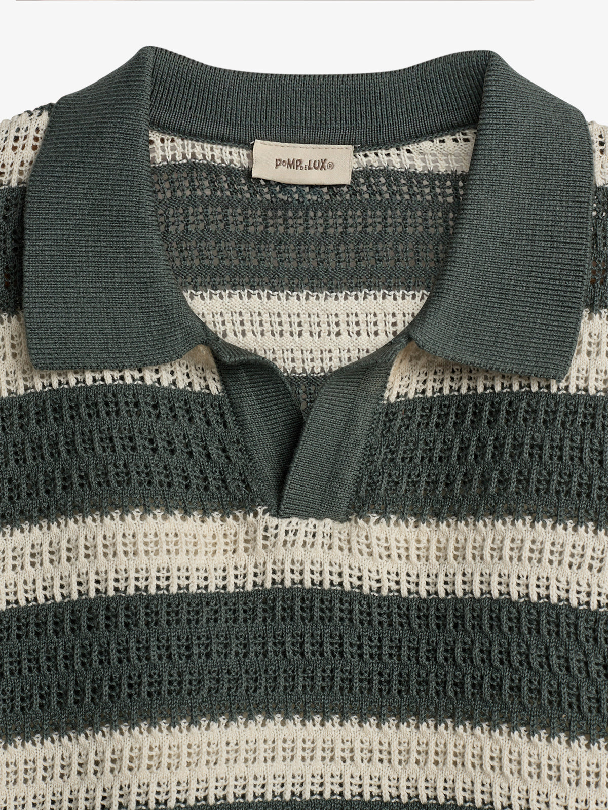 A knit collared shirt features dark green and cream horizontal stripes in a textured pattern. A label reads "POMPdeLUX" on the inner collar, set against a plain background.