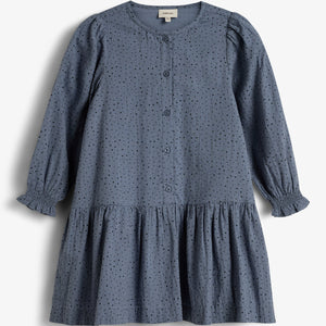 A blue, long-sleeved dress features small perforated holes and buttons down the front, with a gathered skirt. It hangs against a plain white background.