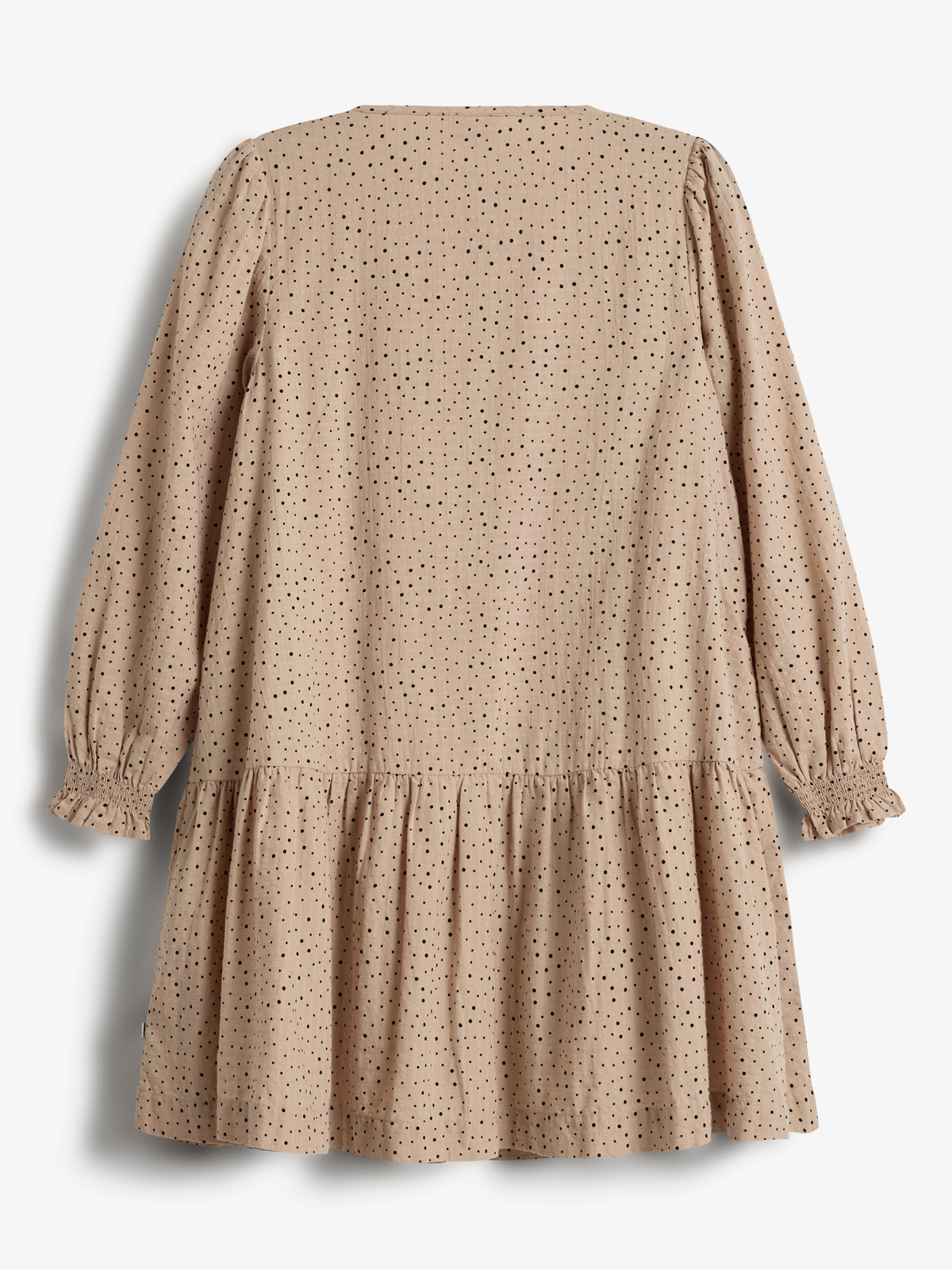 A beige dress with black polka dots hangs against a white background, featuring long sleeves with gathered cuffs and a tiered skirt.