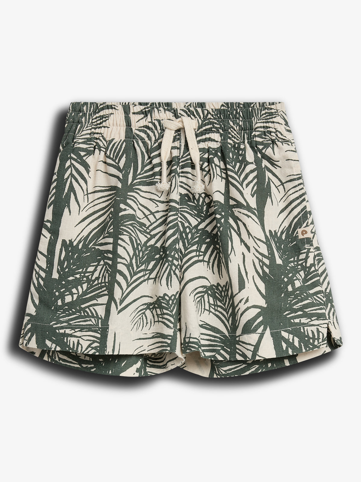 Shorts with a drawstring waistband feature a green palm leaf pattern against a beige background, positioned on a plain white surface.