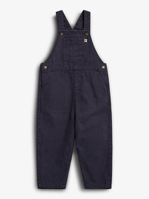 Dark blue overalls with adjustable shoulder straps and front pocket, lying flat on a plain white background. Made from durable fabric and featuring metal button attachments on the sides.