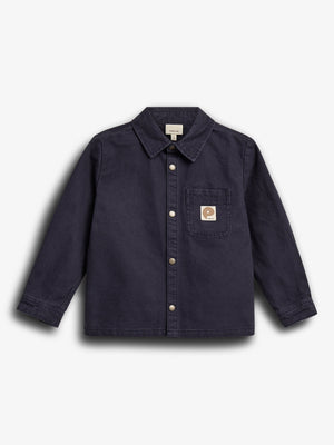 A dark blue button-up shirt with a collar is displayed, featuring a logo on the chest pocket. The background is plain white, emphasizing the garment's design.