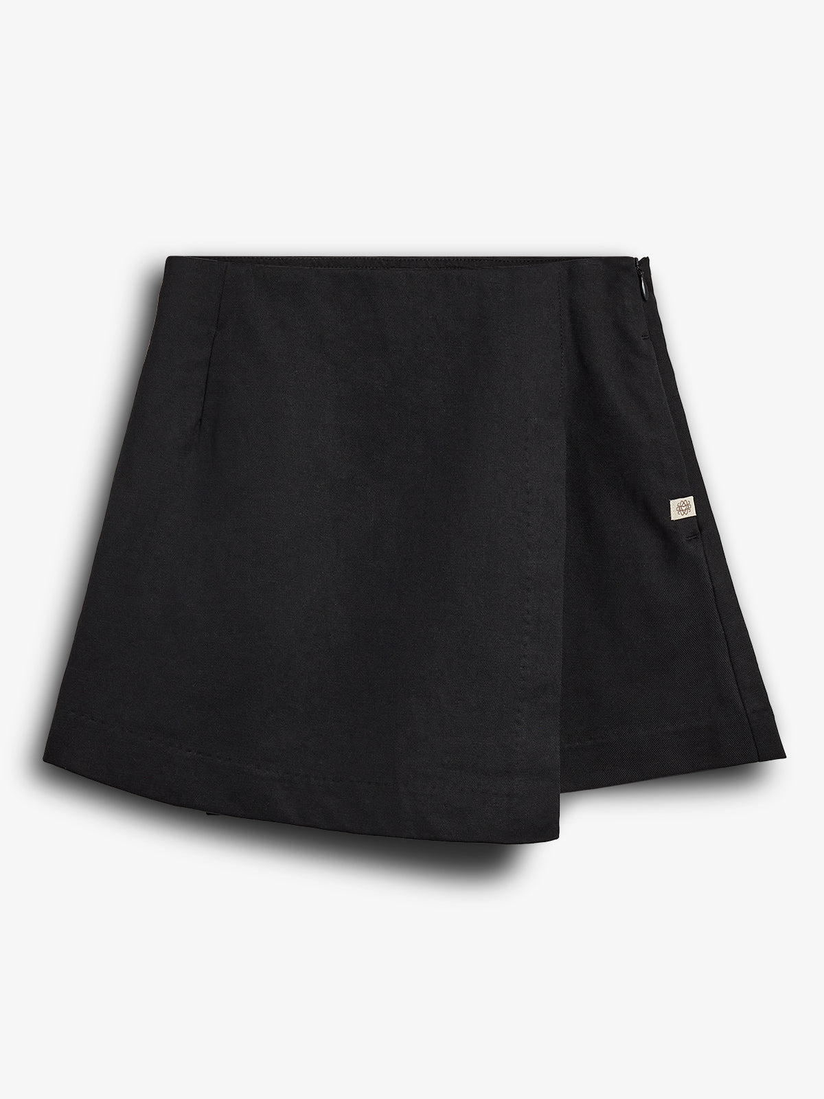 A black, A-line mini skirt with a wrap-style front and a small tag on the right side. Displayed against a solid white background.