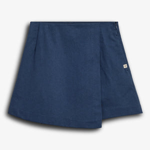 A navy blue skort with pleats and a side zipper is displayed against a plain white background, featuring a small rectangular label on the side.