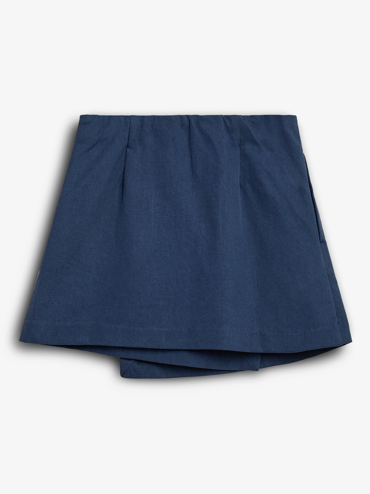 Blue pleated skirt laying flat, displaying a layered hem, against a plain white background. The fabric appears smooth and lightweight, emphasizing a simple and classic design.