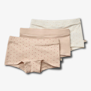 Three pairs of women's pastel underwear are arranged in a staggered stack. Each pair features small heart patterns and is set against a plain white background.