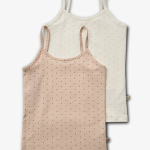 Two sleeveless tops with spaghetti straps are laid flat. One is beige, one white, both featuring small dotted heart patterns. They overlap slightly, set against a plain background.