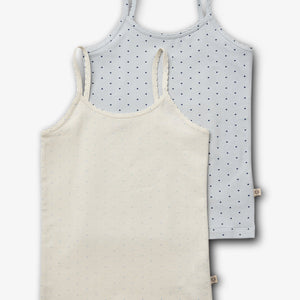 Two sleeveless camisoles; one cream, one light blue, both with small dotted patterns. They're layered on a plain white background, highlighting their delicate fabric and simple design.