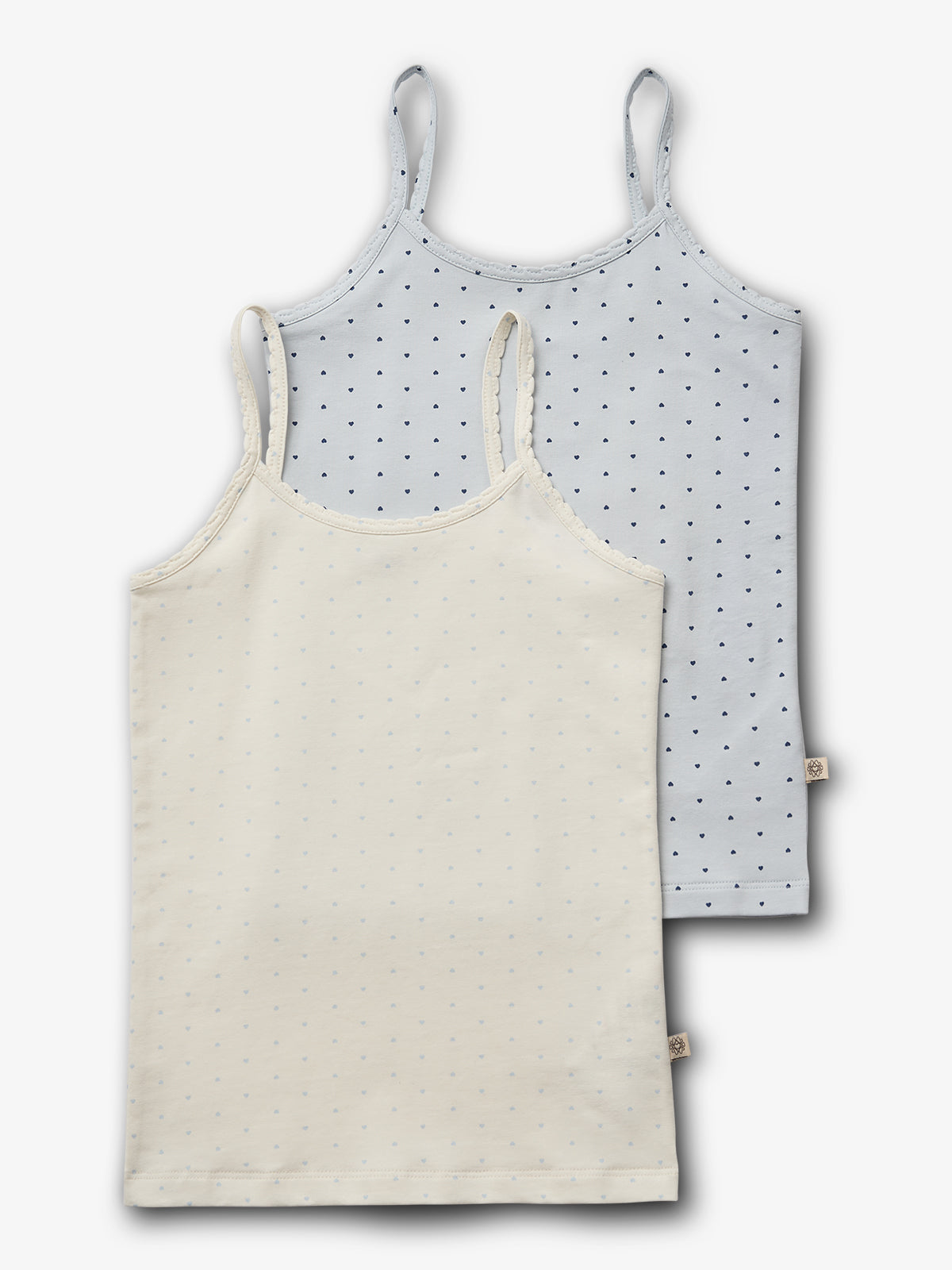 Two sleeveless camisoles; one cream, one light blue, both with small dotted patterns. They're layered on a plain white background, highlighting their delicate fabric and simple design.