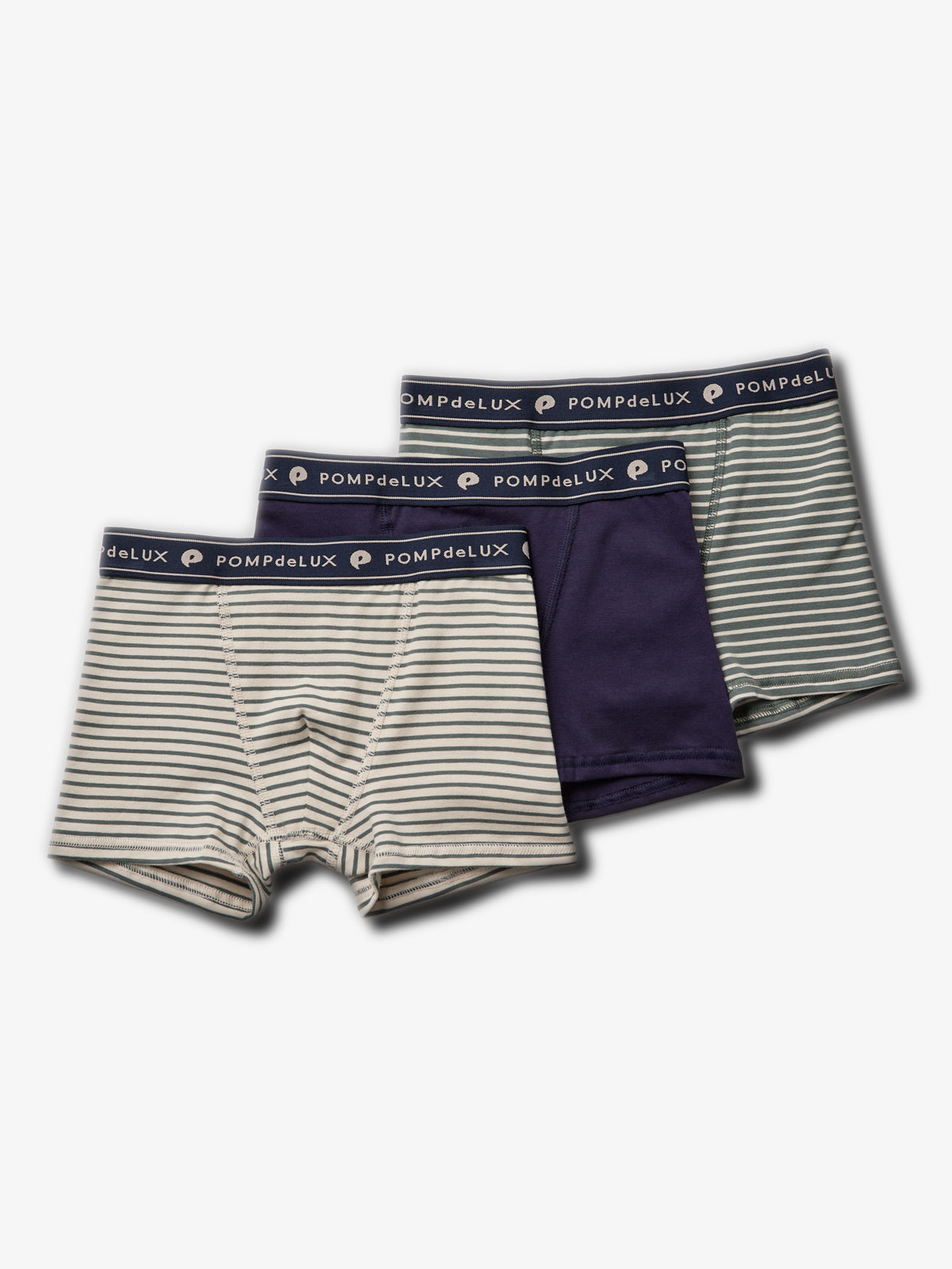 Three pairs of children’s boxer shorts are arranged. The first and third pairs have horizontal stripes, while the second is solid navy. All feature "POMPdeLUX" printed on the waistband, placed on a plain white background.