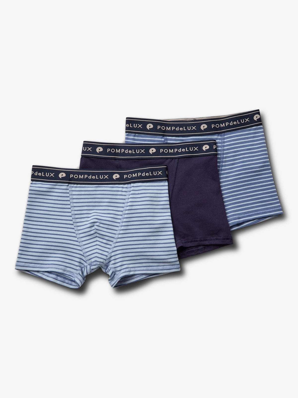Three pairs of boys' underwear are displayed: two with light and dark blue stripes, one solid navy, labeled "POMPdeLUX" on the waistband, against a plain white background.