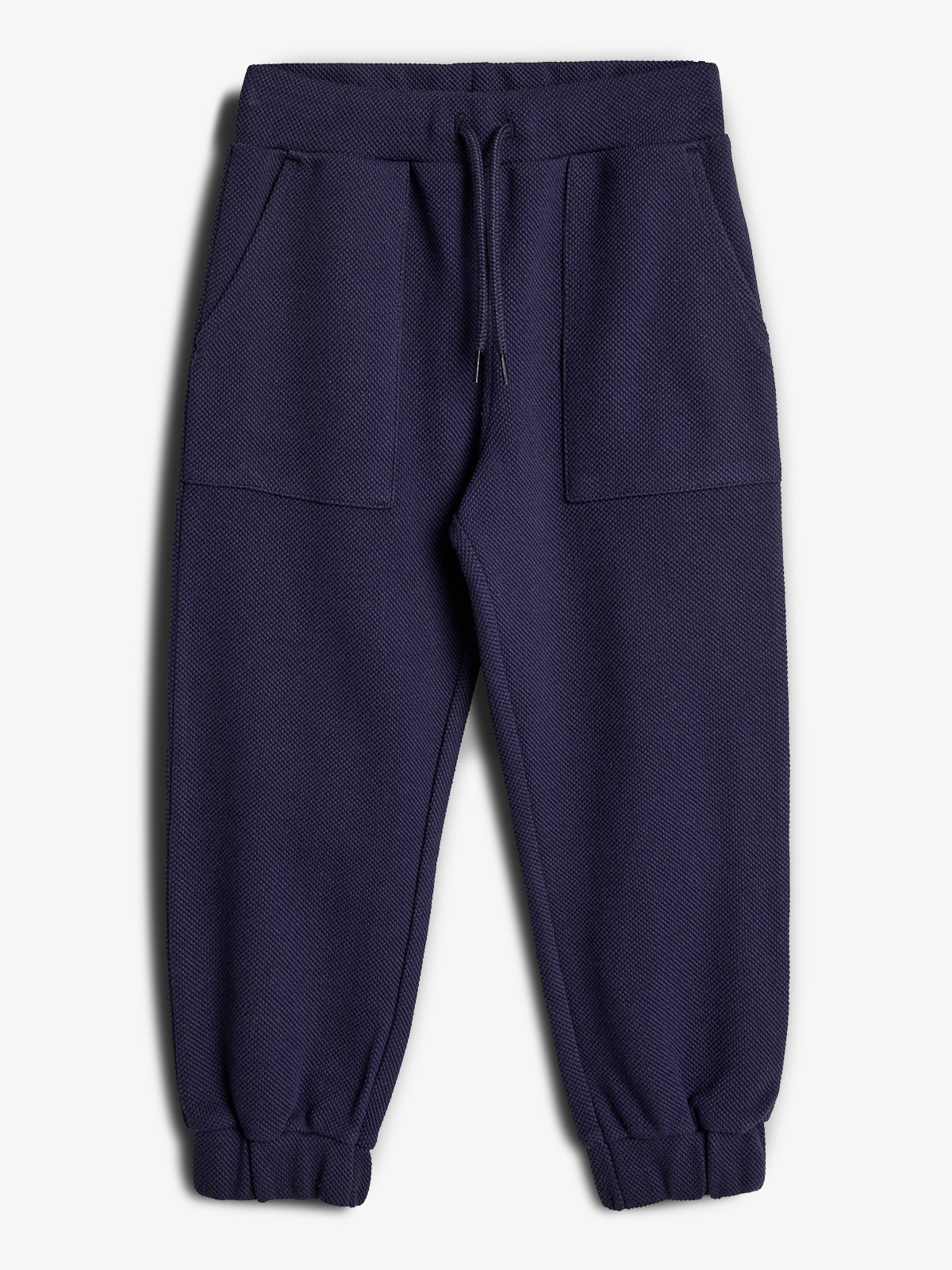 Navy blue sweatpants lie flat with a drawstring waistband, elastic cuffs, and large front pockets, set against a plain white background.