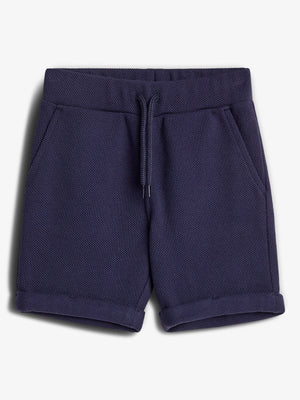 Dark blue shorts lie flat, featuring a textured fabric, drawstring waist, and pockets. They have folded cuffs, placed against a plain white background.