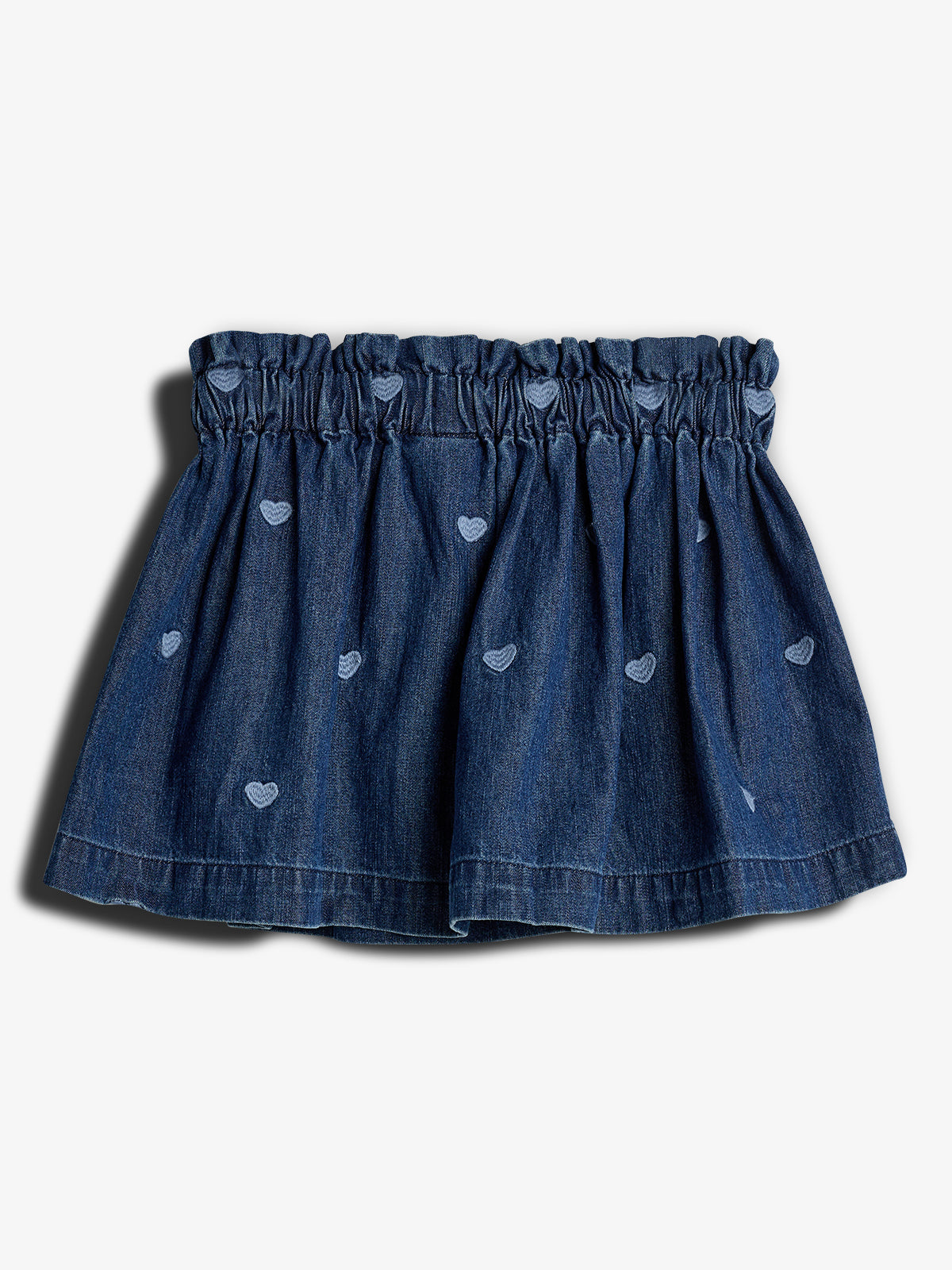 Denim skirt features gathered elastic waistband and small embroidered hearts scattered throughout. It is displayed on a plain, light background.