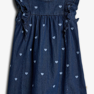 Denim dress features ruffled sleeves and a pattern of embroidered light blue hearts, set against a white background. The label inside reads "Primark."
