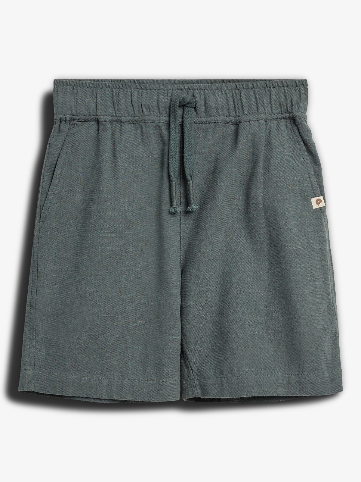 Gray shorts with a drawstring waistband and side pockets rest on a plain white background. A small label is attached near the hem.