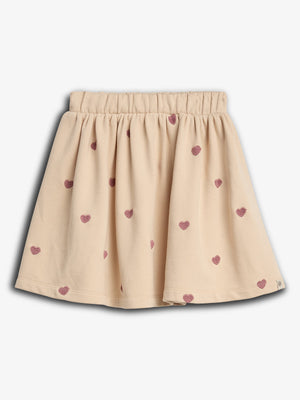 The skirt has an elastic waistband with a light beige color patterned with small, pink heart designs, against a plain white background.