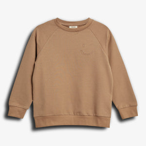 A tan sweatshirt with ribbed cuffs and hem lies flat on a plain white background. The text "PLAYFUL" and "POMPDELUX" is subtly embossed on the front.