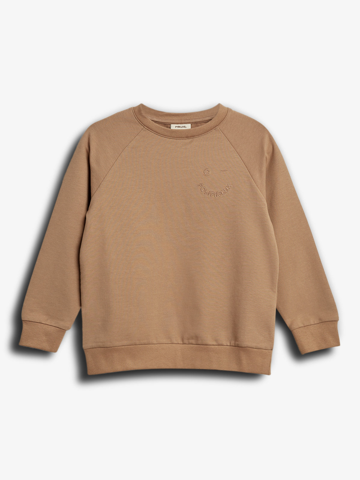 A tan sweatshirt with ribbed cuffs and hem lies flat on a plain white background. The text "PLAYFUL" and "POMPDELUX" is subtly embossed on the front.