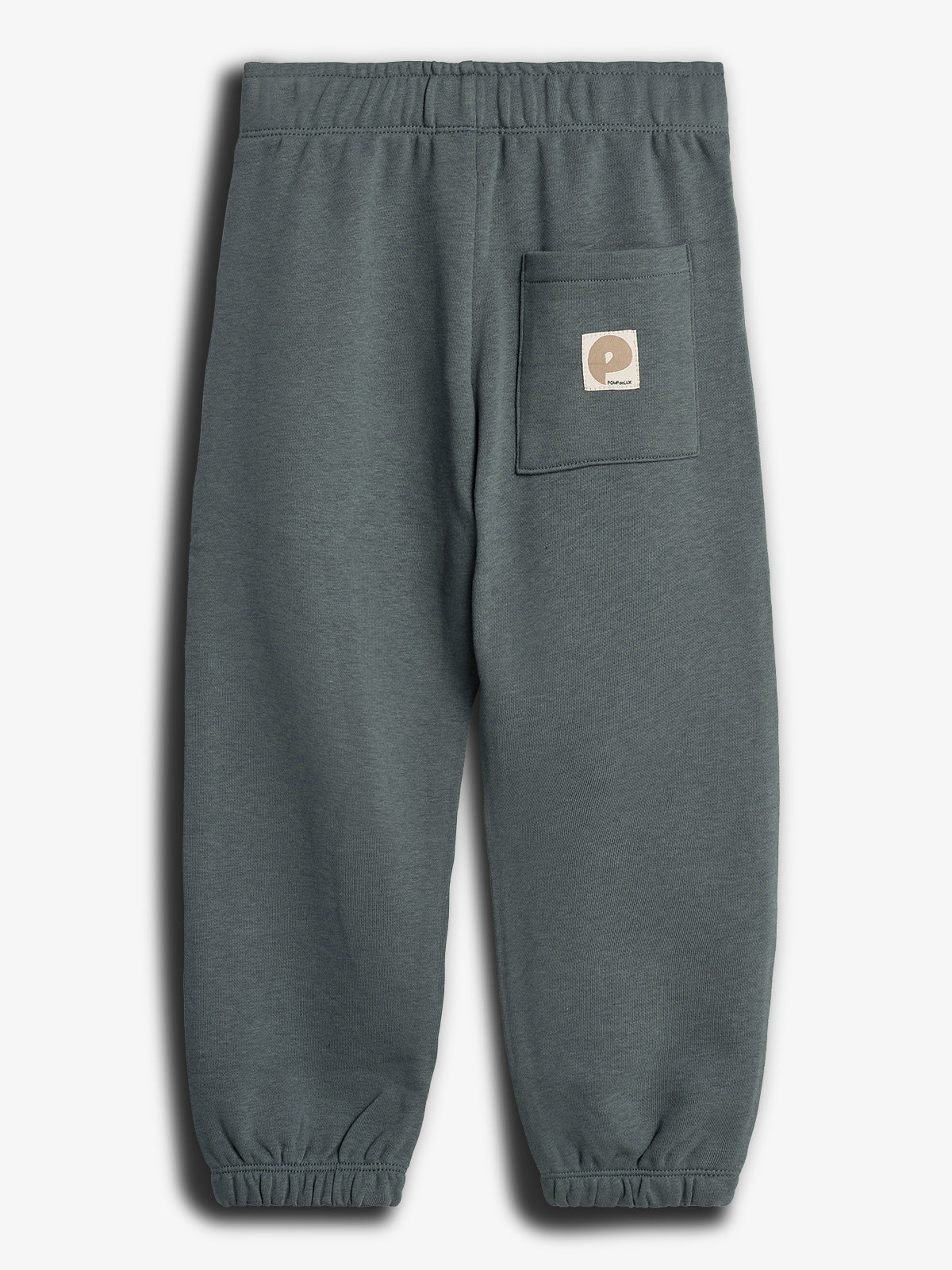 Gray jogger pants with an elastic waistband and cuffs feature a patch pocket on the right side. A small square label with "POP TRADING" text is attached to the pocket.