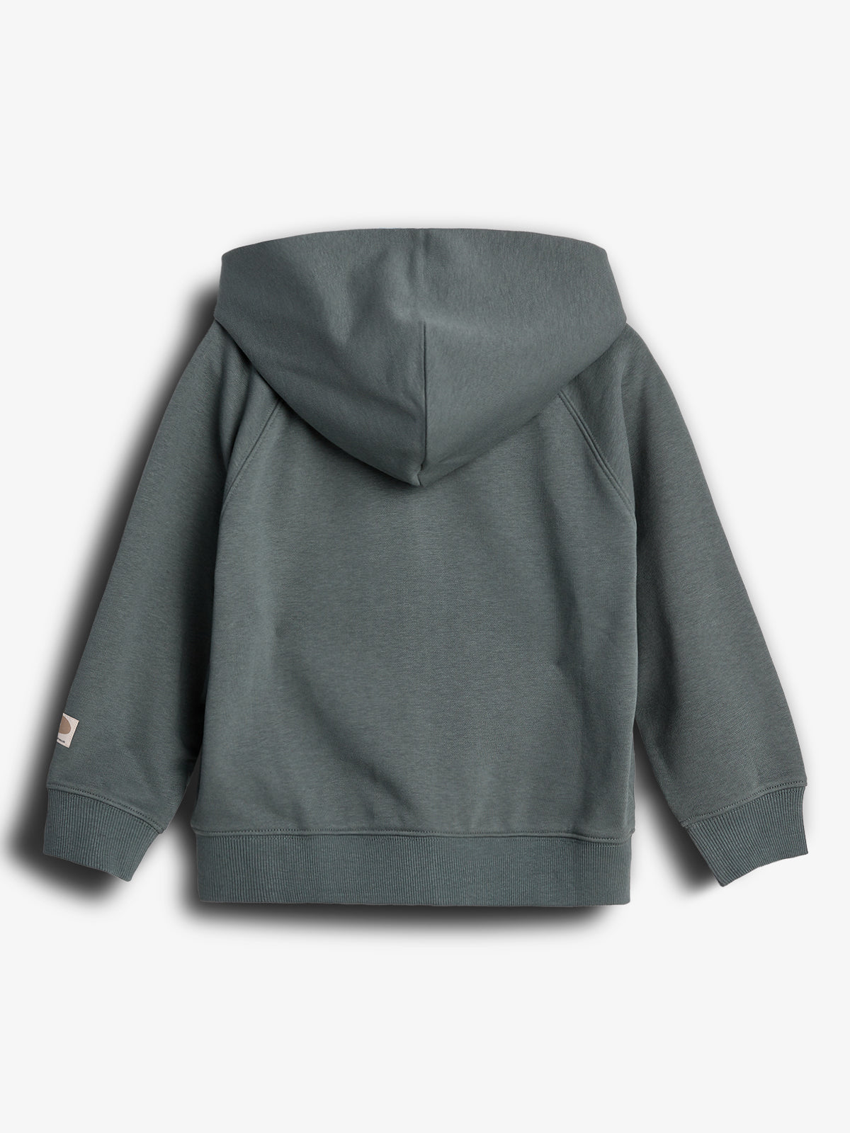 A grey hoodie is laid flat with the back visible, displaying a hood and ribbed cuffs. The item rests against a plain white background, with a tag on the left sleeve.