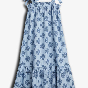A light blue dress with shoulder ties features a pattern of dark blue floral motifs. It has a ruffled hemline and is displayed against a plain white background.