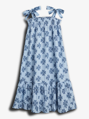 A light blue dress with shoulder ties features a pattern of dark blue floral motifs. It has a ruffled hemline and is displayed against a plain white background.