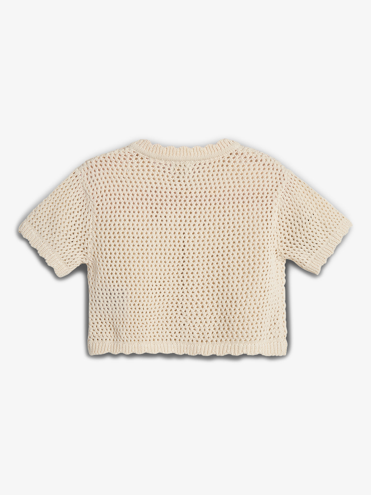 A cream-colored, short-sleeved, open-knit sweater is laid flat, showcasing its textured pattern. It has a ribbed neckline, cuffs, and hem, set against a plain white background.
