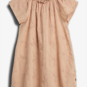 A peach-colored floral dress with short sleeves hangs against a plain backdrop. The fabric displays delicate embroidered flowers, and the neckline is slightly gathered for a ruffled effect.