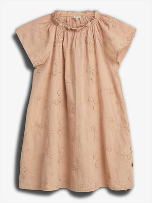 Peach-colored dress lies flat, featuring short sleeves and floral embroidery, set against a plain white backdrop.