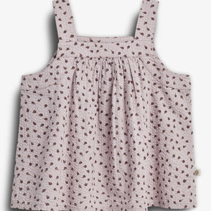 A sleeveless, light pink top is adorned with a pattern of small brown flowers. It features wide straps and a loose, gathered design. The background is plain white.