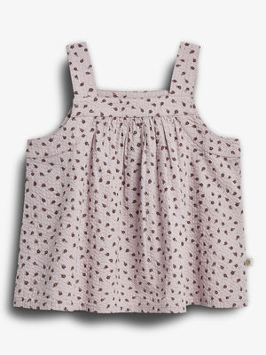 A sleeveless, light pink top is adorned with a pattern of small brown flowers. It features wide straps and a loose, gathered design. The background is plain white.