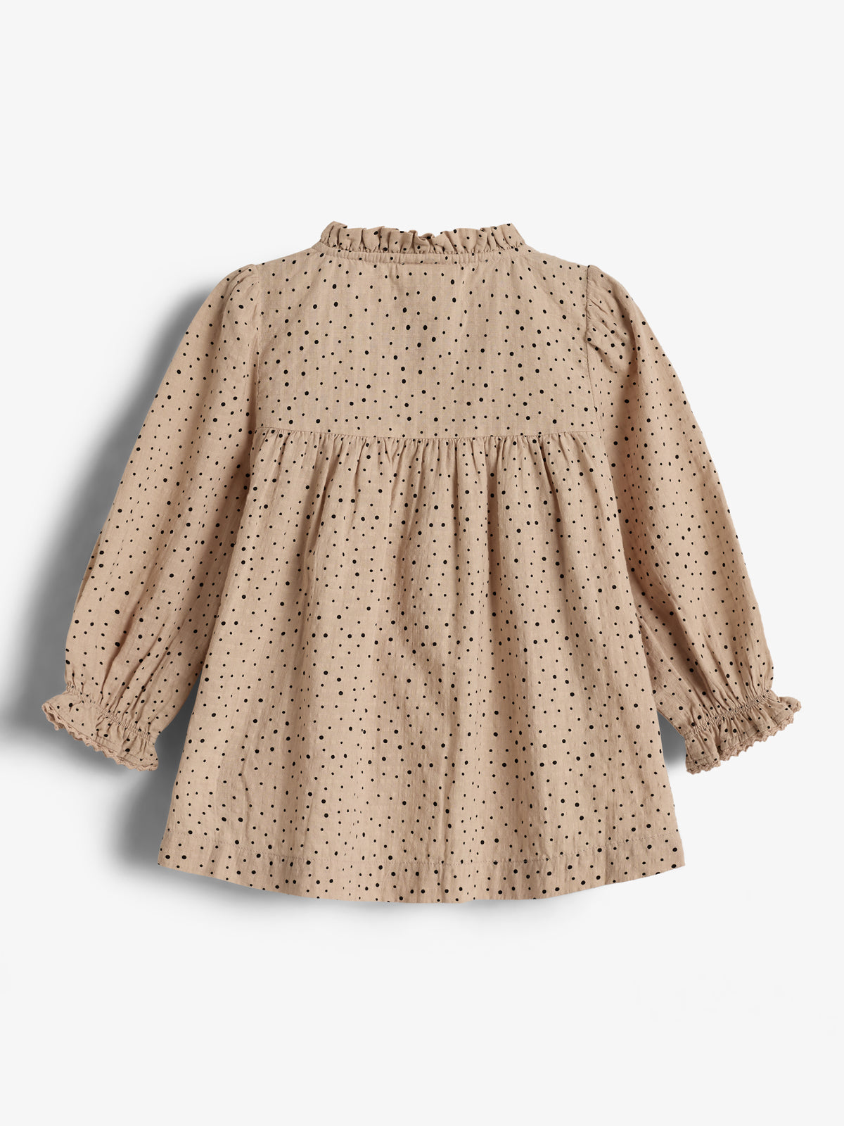 A beige long-sleeve dress features black polka dots, ruffled cuffs, and a gathered waist, displayed against a plain white background.