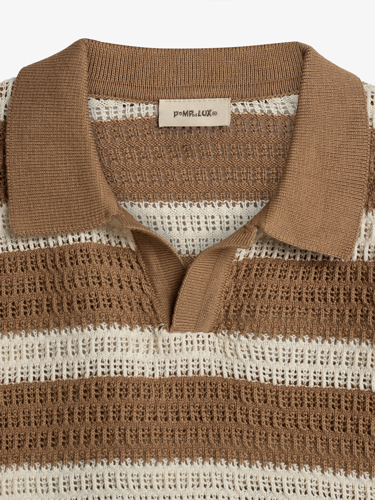 A striped brown and white knit shirt with a collar is displayed. The shirt features a tag reading "PoMp.eLuX©." The background is solid white, highlighting the garment.