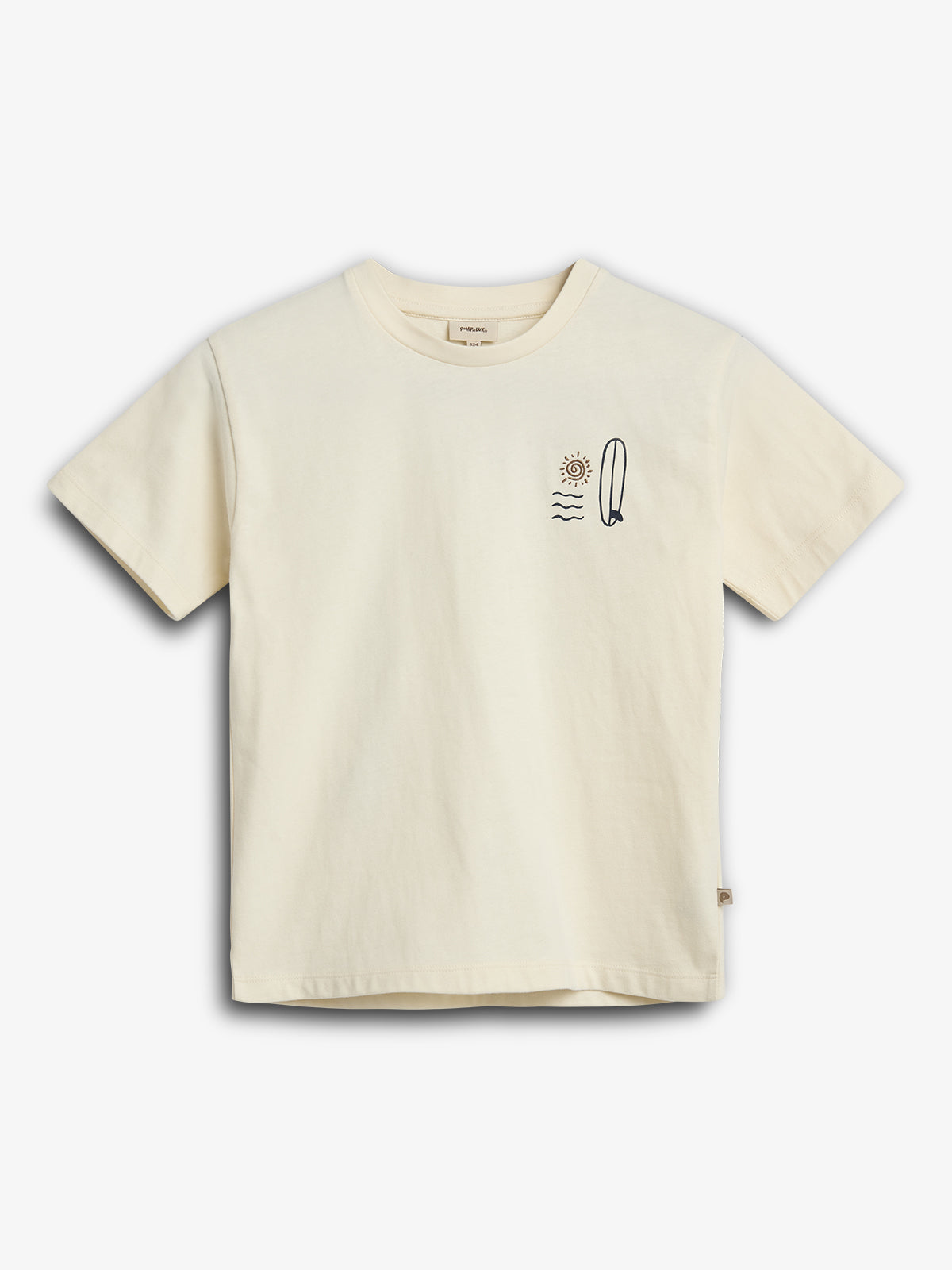 Cream-colored T-shirt displaying a minimalist design featuring a sun, waves, and a surfboard on the left chest. The background is plain white, emphasizing the shirt's simplicity.