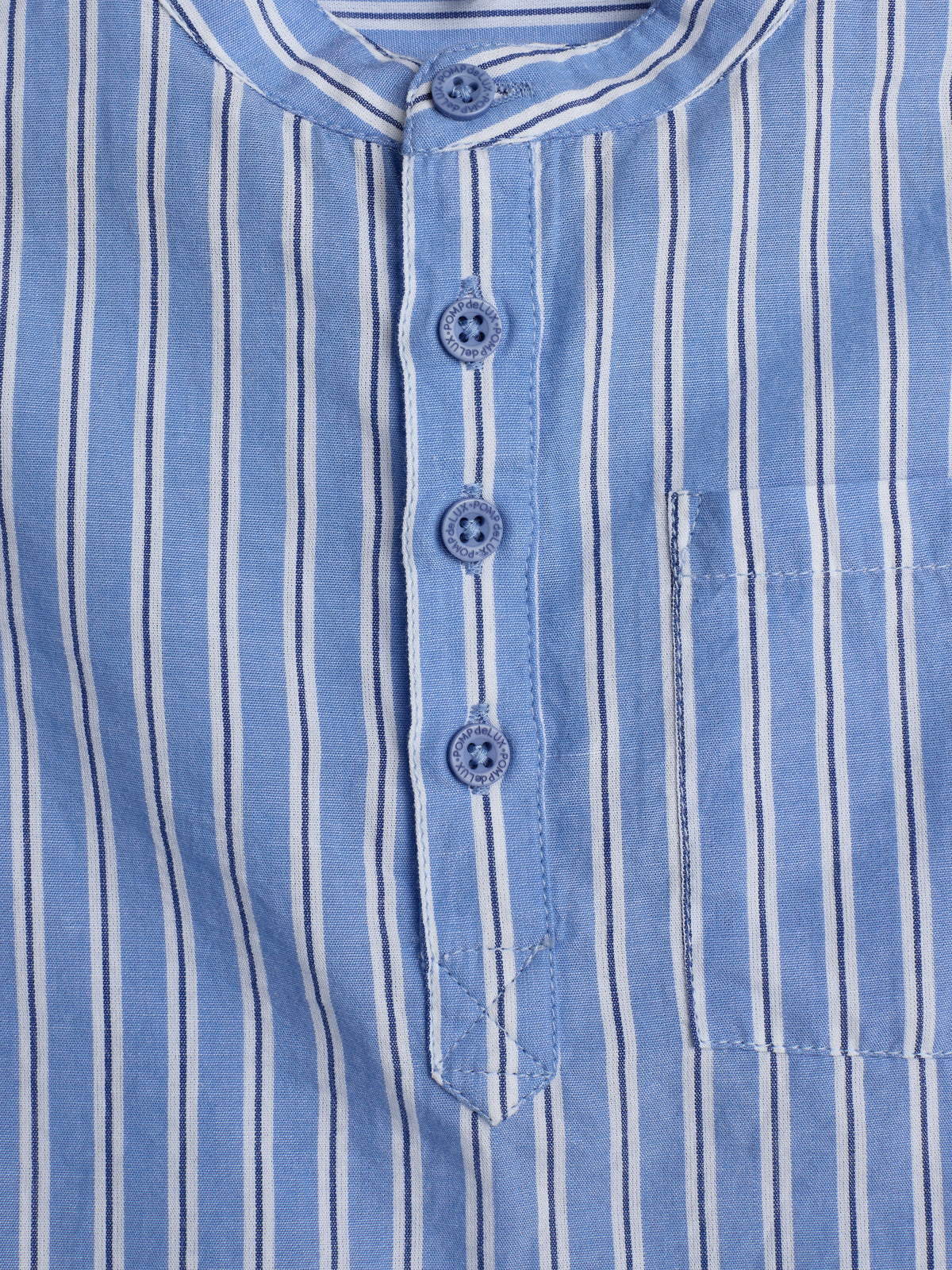 Blue and white vertically-striped shirt with a rounded collar and four buttons, showcasing a small chest pocket on the right. The setting is a plain background.
