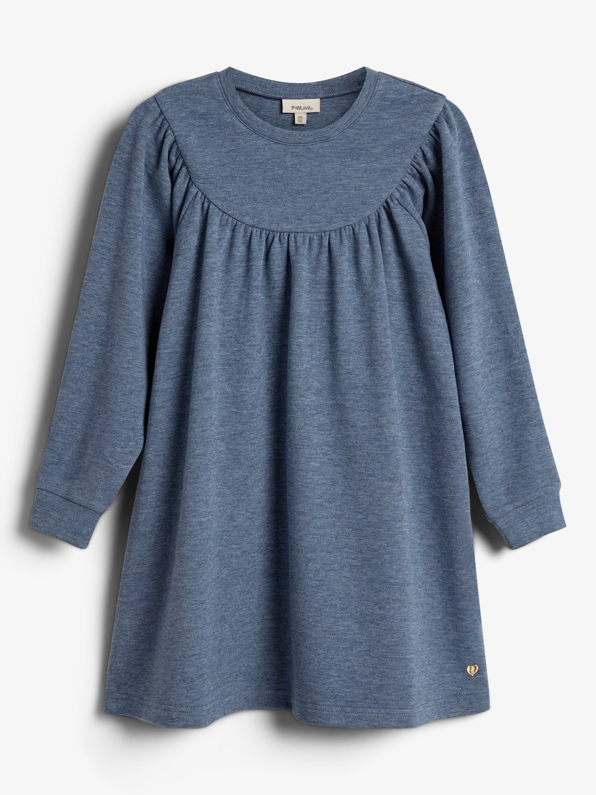Ein blaues langärmeliges Kleid hängt vor einem weißen Hintergrund. Es hat einen runden Ausschnitt und einen gerafften Schulterbereich. Ein kleines goldenes Herz ist am Saum befestigt.