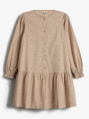 A tan, long-sleeved dress with black polka dots is neatly displayed. It features buttons down the front and a gathered hem, hanging against a plain white background.