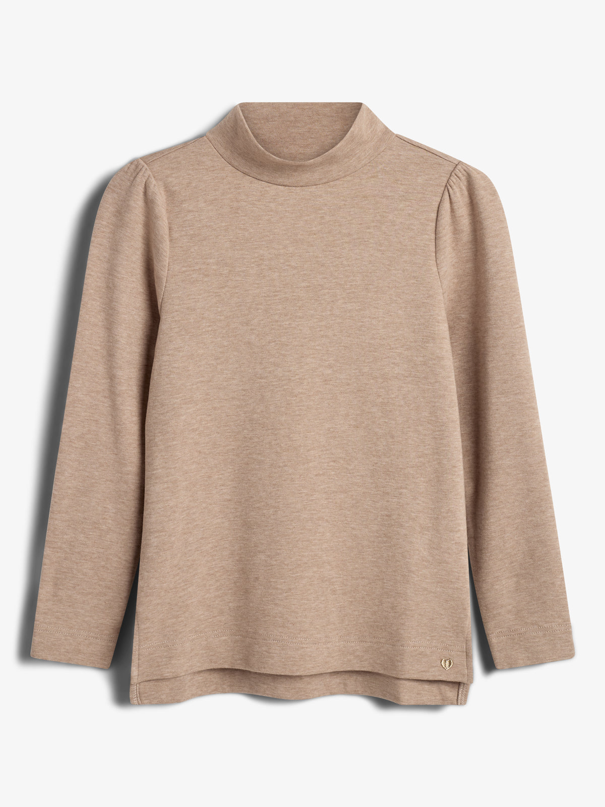 Beige long-sleeve turtleneck top hanging against a plain white background. The fabric appears soft, with a slight drape under the collar. A small metallic logo embellishes the lower edge.